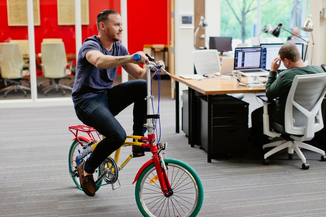 samuel riding google bike in adept office